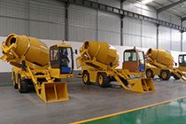 Self-loading mobile concrete mixer